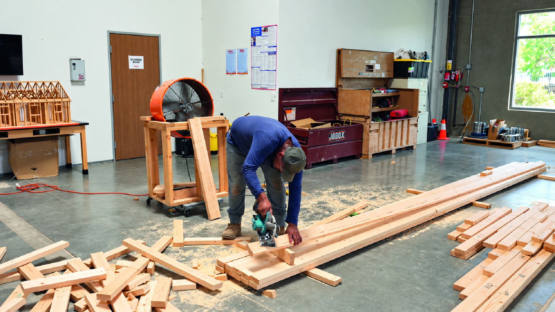 Omega fabricator cutting lumber for a truss package on the shop floor